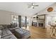 Bright living room features a brick fireplace, wood floors, and sliding doors to the outdoor patio at 359 Westwind Ct, Lake Mary, FL 32746