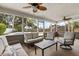 Spacious screened-in patio with fan, couch, and chairs, perfect for entertaining at 359 Westwind Ct, Lake Mary, FL 32746