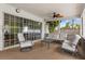 Relaxing screened-in patio with comfortable seating and ceiling fan at 359 Westwind Ct, Lake Mary, FL 32746