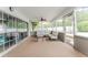 Enclosed patio with comfortable seating, offering a relaxing outdoor living space at 359 Westwind Ct, Lake Mary, FL 32746