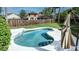 Inviting backyard featuring a sparkling pool, lush greenery, and a wooden fence for privacy at 359 Westwind Ct, Lake Mary, FL 32746