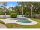 Backyard with a kidney-shaped pool, green grass, and lush tropical landscaping at 359 Westwind Ct, Lake Mary, FL 32746