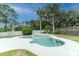 Relaxing pool area with palm trees, a sun umbrella, and a well-maintained lawn at 359 Westwind Ct, Lake Mary, FL 32746