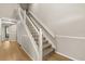 Carpeted staircase featuring white banisters and a white baseboard, leading to the second floor at 359 Westwind Ct, Lake Mary, FL 32746