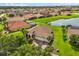 Aerial view of a lakeside home with a private pool and well-manicured lawn at 3847 Shoreside Dr, Kissimmee, FL 34746