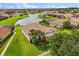 Aerial view of a home with a tile roof, lush lawn, and waterfront access at 3847 Shoreside Dr, Kissimmee, FL 34746