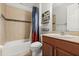 This bathroom boasts a tub with tile surround, a single sink vanity and tiled floors at 3847 Shoreside Dr, Kissimmee, FL 34746