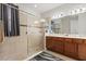 Modern bathroom with a glass shower, double vanity, and neutral tile at 3847 Shoreside Dr, Kissimmee, FL 34746