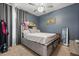 This bedroom has a gray accent wall, a ceiling fan, and a gray bed frame at 3847 Shoreside Dr, Kissimmee, FL 34746