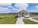 Community gazebo with picnic table, benches and picturesque views of the adjacent pond at 3848 Corsican Pl, Lake Alfred, FL 33850