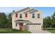 Charming two-story home with beige siding, red shutters, a two-car garage and a well maintained lawn at 3852 Corsican Pl, Lake Alfred, FL 33850