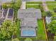 An aerial view of a home featuring a screen-enclosed pool and well-maintained landscaping at 3902 Brandeis Ave, Orlando, FL 32839
