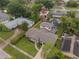Aerial view of a home with a well-maintained lawn and proximity to other homes, a pool, and mature landscaping at 3902 Brandeis Ave, Orlando, FL 32839