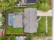 Aerial view of home featuring a screened-in pool, patio, and spacious yard at 3902 Brandeis Ave, Orlando, FL 32839