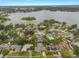 Areal view of a lakeside neighborhood with tree coverage and waterfront homes at 3902 Brandeis Ave, Orlando, FL 32839