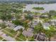 Beautiful aerial view of neighborhood with mature trees, lake, and waterfront houses at 3902 Brandeis Ave, Orlando, FL 32839