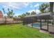 Large backyard featuring a screened-in pool area at 3902 Brandeis Ave, Orlando, FL 32839