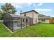 Spacious backyard with a screened-in pool and lovely home exterior at 3902 Brandeis Ave, Orlando, FL 32839