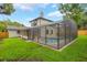 Expansive backyard showcasing the screened-in pool and home's exterior at 3902 Brandeis Ave, Orlando, FL 32839