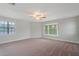 Bright bedroom with neutral carpet, large windows, and a ceiling fan at 3902 Brandeis Ave, Orlando, FL 32839