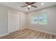 Bright bedroom with wood flooring, a ceiling fan, a closet, and a window at 3902 Brandeis Ave, Orlando, FL 32839