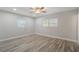 Bedroom featuring modern wood-style flooring, natural light, and neutral walls at 3902 Brandeis Ave, Orlando, FL 32839