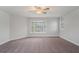 Large bedroom with a bay window, a ceiling fan, and neutral colored carpeting at 3902 Brandeis Ave, Orlando, FL 32839