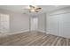 Bedroom with wood-look flooring, ensuite access, and a double-door closet at 3902 Brandeis Ave, Orlando, FL 32839