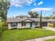 Charming single-story home with a well-maintained front yard and blue door at 3902 Brandeis Ave, Orlando, FL 32839