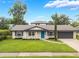 Beautiful home with a manicured lawn and a bright blue front door at 3902 Brandeis Ave, Orlando, FL 32839