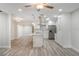 Modern kitchen with white cabinetry, a stainless steel refrigerator, and a view into the living area at 3902 Brandeis Ave, Orlando, FL 32839