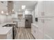 Stylish kitchen features stainless steel appliances and white cabinets with quartz countertops at 3902 Brandeis Ave, Orlando, FL 32839