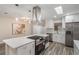 Renovated kitchen featuring stainless appliances, quartz countertops, and stylish pendant lights at 3902 Brandeis Ave, Orlando, FL 32839