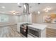 Updated kitchen features stainless appliances, quartz countertops, and sleek vent hood at 3902 Brandeis Ave, Orlando, FL 32839