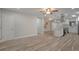 Bright living room with wood-look tile floors flows into the open kitchen at 3902 Brandeis Ave, Orlando, FL 32839