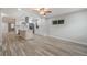 Open-concept living and kitchen space, showcasing the modern design and wood-look tile flooring at 3902 Brandeis Ave, Orlando, FL 32839