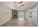 Cozy living space with wood-look tile, stone fireplace, and sliding glass door to backyard at 3902 Brandeis Ave, Orlando, FL 32839