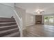 Living room showcasing an inviting stone fireplace, staircase, and wood-style flooring at 3902 Brandeis Ave, Orlando, FL 32839