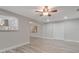 Bright living room with wood-look tile floors, ceiling fan, and convenient access to the kitchen at 3902 Brandeis Ave, Orlando, FL 32839