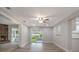 Open-concept living room featuring wood floors, stone fireplace, and access to a screened-in patio at 3902 Brandeis Ave, Orlando, FL 32839