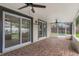 Screened-in porch with brick floors, ceiling fans, leading to fenced yard and enclosed pool at 3902 Brandeis Ave, Orlando, FL 32839