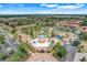Aerial view of community clubhouse, pool and surrounding condo community, all set amidst lush trees at 3938 Calabria Ave, Davenport, FL 33897