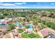 Aerial view of resort-style pool and tropical landscaping surrounded by residential community at 3938 Calabria Ave, Davenport, FL 33897