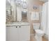 Bright bathroom featuring a vanity with a granite countertop and a shower with curtain at 3938 Calabria Ave, Davenport, FL 33897