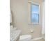 Clean bathroom view of toilet and window at 3938 Calabria Ave, Davenport, FL 33897