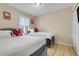 Charming bedroom with two beds, a sunny window, and playful Hello Kitty decor at 3938 Calabria Ave, Davenport, FL 33897