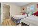 Bright bedroom with two beds, natural light, and wood-look flooring at 3938 Calabria Ave, Davenport, FL 33897