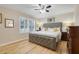 Comfortable bedroom with a ceiling fan, wood floors, and natural light at 3938 Calabria Ave, Davenport, FL 33897