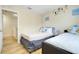 Bright bedroom with two beds and wall decor, adjacent to a staircase at 3938 Calabria Ave, Davenport, FL 33897