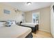 Bright bedroom with two beds, a sunny window, and playful cartoon character decor at 3938 Calabria Ave, Davenport, FL 33897